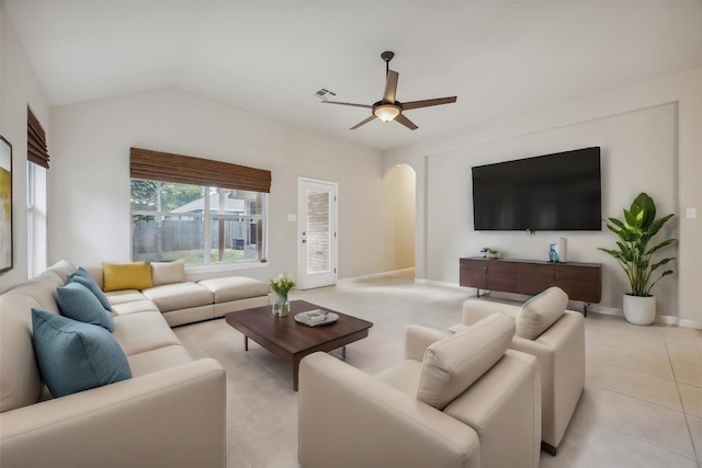 tiled living room with ceiling fan and lofted ceiling