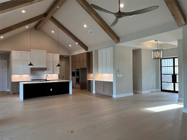 unfurnished living room with ceiling fan, beam ceiling, light hardwood / wood-style floors, and high vaulted ceiling