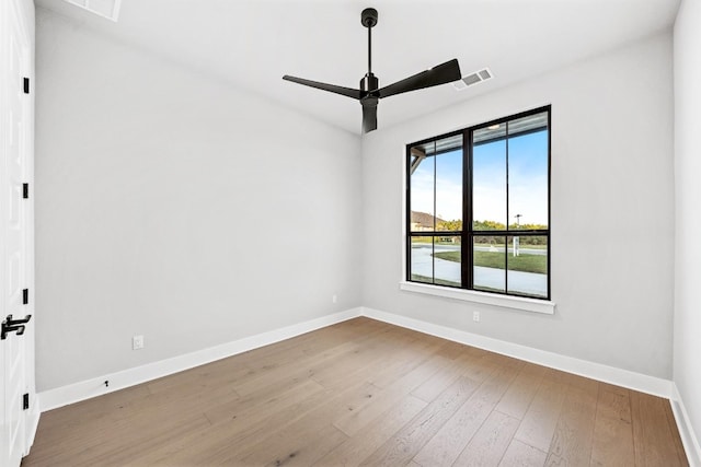 empty room featuring ceiling fan and hardwood / wood-style floors