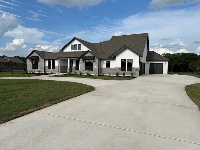 view of front of house featuring a front yard, a porch, and a garage