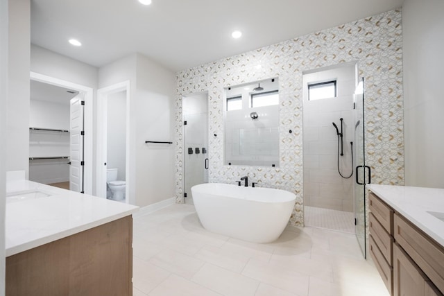 full bathroom featuring shower with separate bathtub, tile patterned flooring, vanity, and toilet