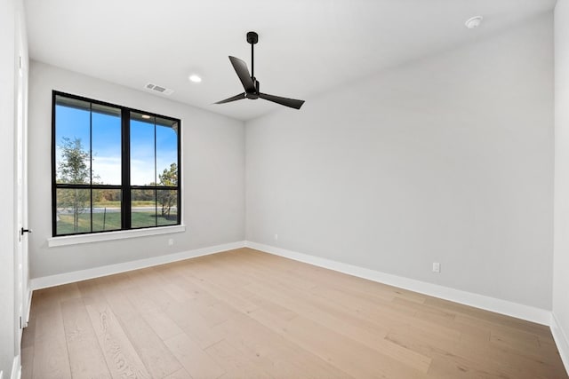 empty room featuring ceiling fan and light wood-type flooring