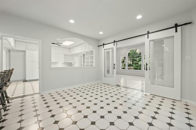 interior space with french doors and ceiling fan