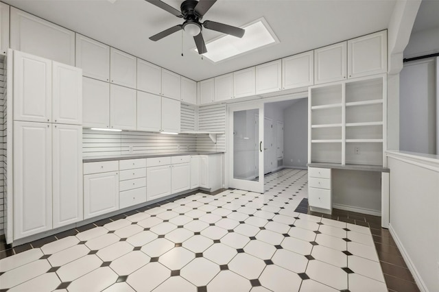 kitchen with white cabinets, tasteful backsplash, and ceiling fan