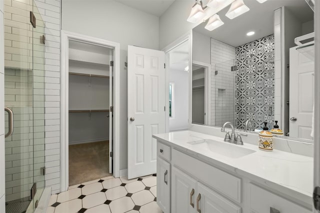 bathroom featuring vanity and a shower with shower door