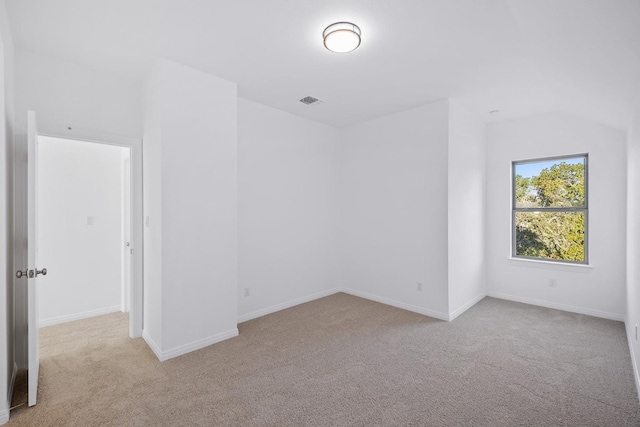 unfurnished room featuring light colored carpet