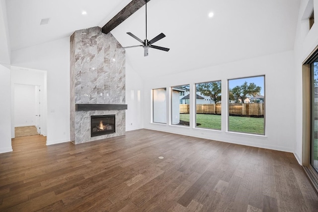 unfurnished living room with hardwood / wood-style flooring, a fireplace, and high vaulted ceiling