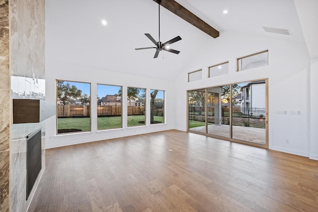 unfurnished sunroom featuring vaulted ceiling with beams and ceiling fan