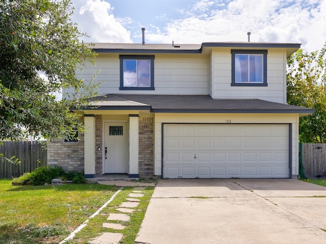 view of front facade featuring a front yard and a garage