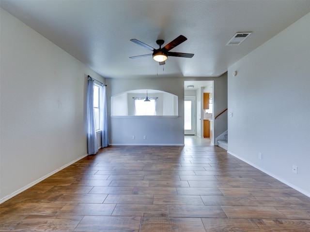 empty room featuring ceiling fan, a textured ceiling, and hardwood / wood-style floors