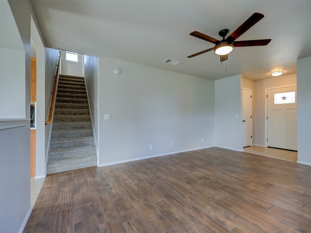 unfurnished living room with ceiling fan and hardwood / wood-style flooring