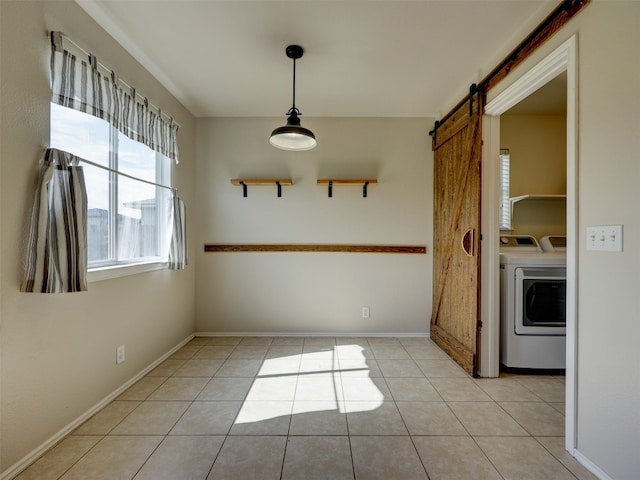 interior space with washing machine and clothes dryer and a barn door