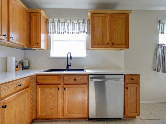 kitchen with sink, dishwasher, and light tile patterned floors