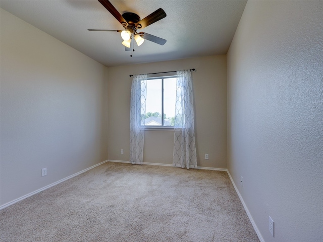 unfurnished room featuring ceiling fan and light carpet