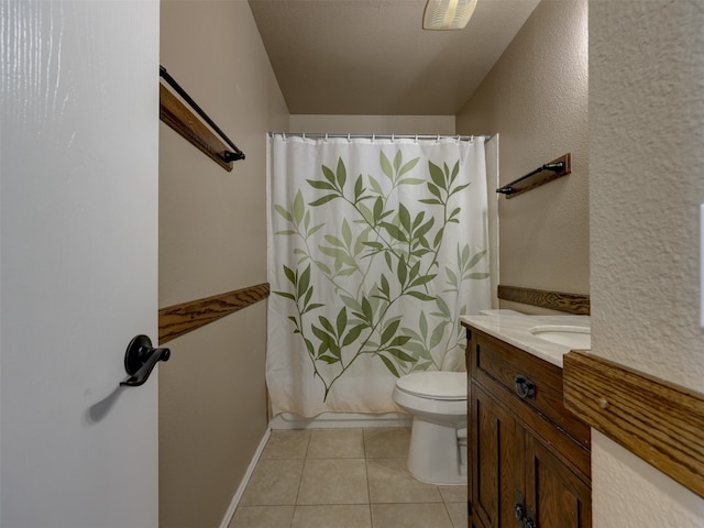 bathroom with tile patterned floors, toilet, a textured ceiling, and vanity