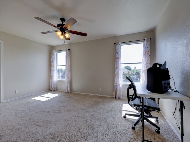 unfurnished office featuring ceiling fan and light colored carpet