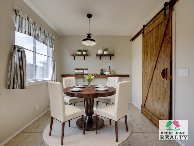 dining area with light tile patterned flooring and a barn door