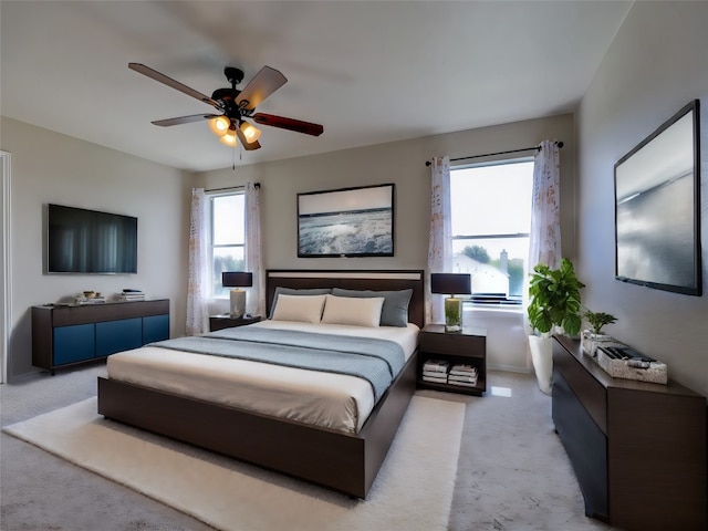 bedroom with ceiling fan and light carpet