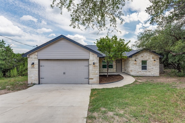 ranch-style home with a garage and a front lawn