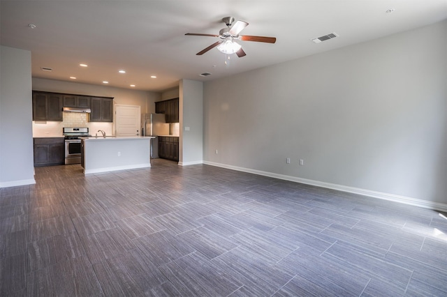 unfurnished living room with sink and ceiling fan