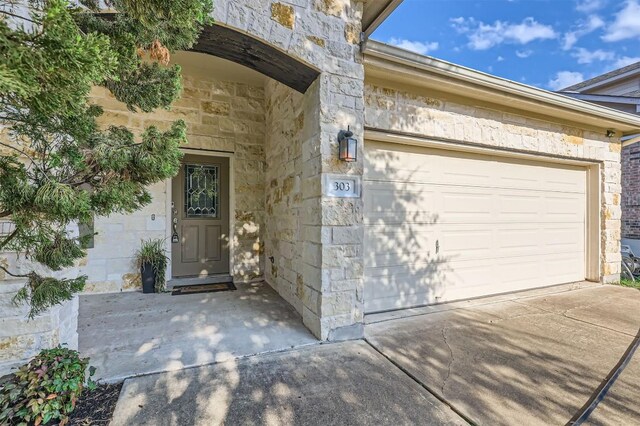 view of exterior entry featuring a garage