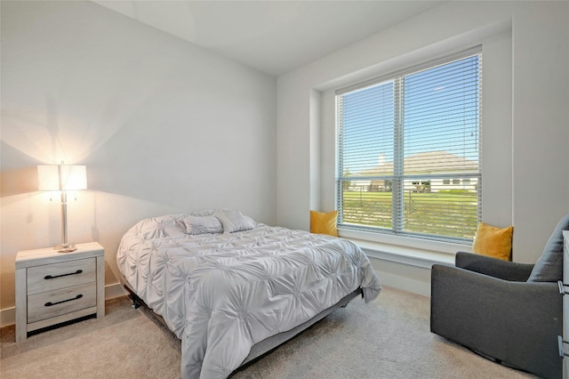 bedroom featuring light carpet