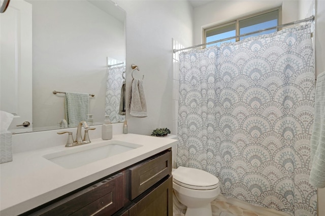 bathroom featuring vanity, tile patterned flooring, and toilet