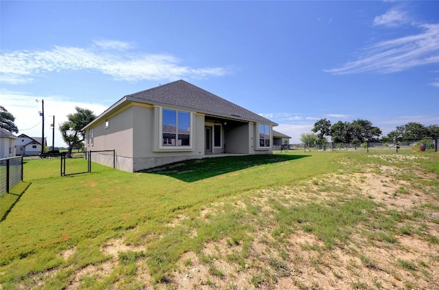 rear view of property with a yard