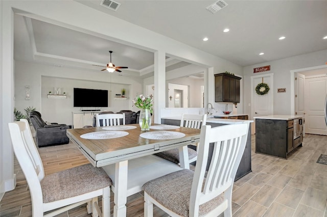 dining space with sink, ceiling fan, and light hardwood / wood-style floors