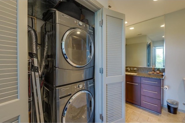 clothes washing area featuring stacked washer / drying machine and sink