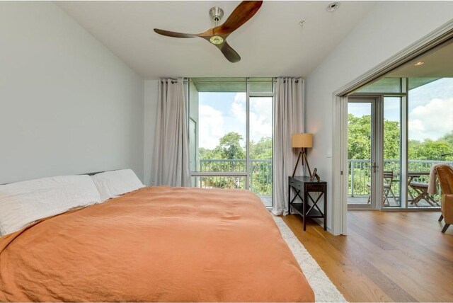 bedroom featuring access to outside, ceiling fan, and light hardwood / wood-style flooring