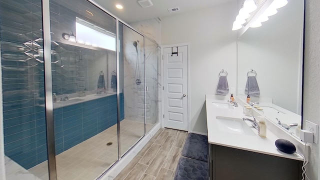 bathroom with an enclosed shower and vanity