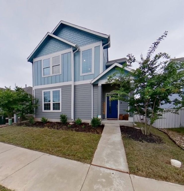 view of front of property featuring board and batten siding and a front yard