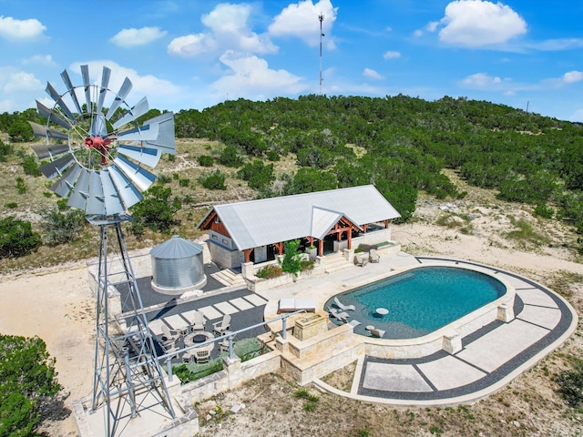 view of pool with a patio area and an outdoor structure