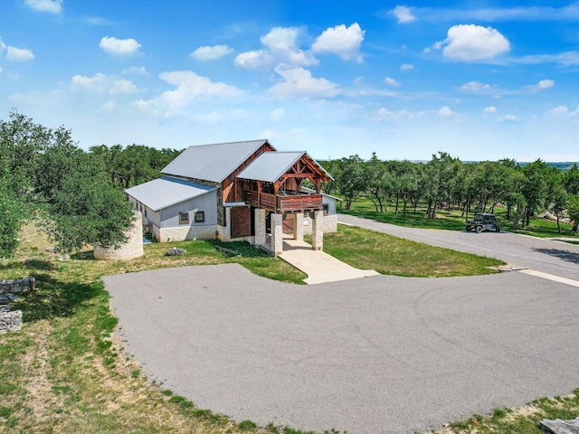 view of front facade with a front yard and a rural view