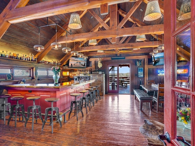 bar with high vaulted ceiling, wooden walls, wood-type flooring, wood ceiling, and beam ceiling