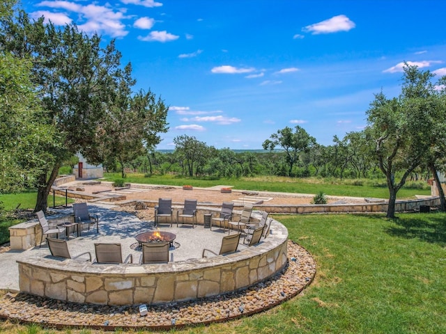 view of yard featuring a patio and a fire pit