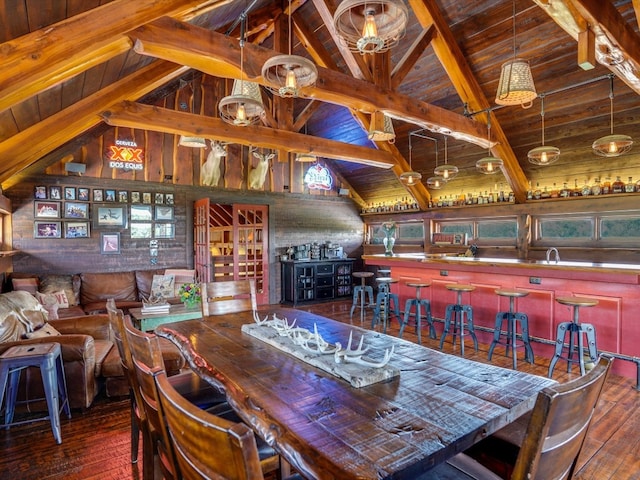 dining space with bar, dark hardwood / wood-style floors, wooden ceiling, beamed ceiling, and wood walls