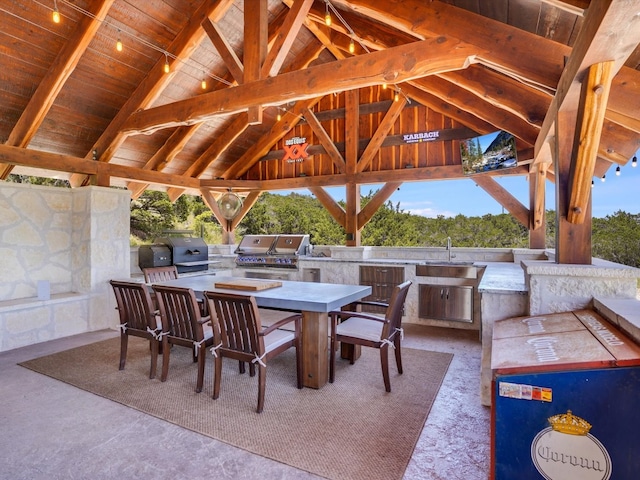 view of patio with exterior kitchen, a gazebo, sink, and grilling area