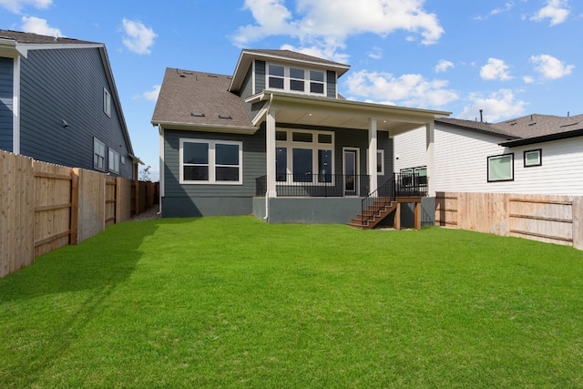 rear view of house featuring a yard