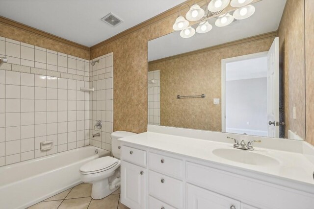 full bathroom featuring vanity, tiled shower / bath, toilet, and tile patterned floors