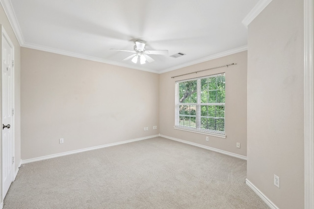 spare room featuring crown molding, light colored carpet, and ceiling fan