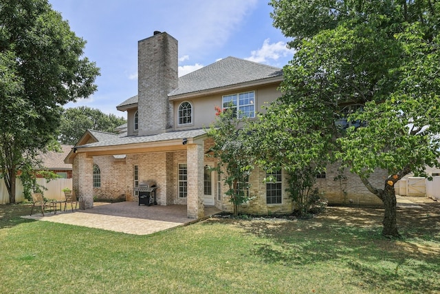 back of property featuring a patio and a yard