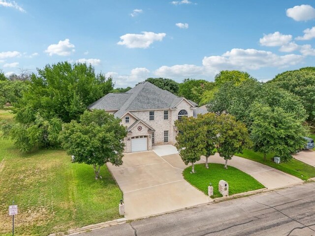 view of front of home with a garage and a front lawn