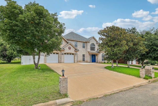 view of front of home with a garage and a front lawn