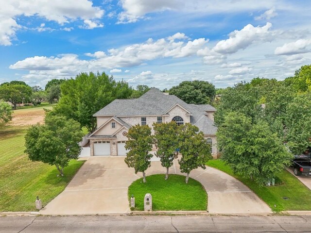 view of front of home featuring a garage and a front lawn