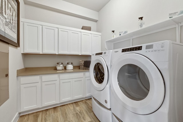 washroom with cabinets and independent washer and dryer