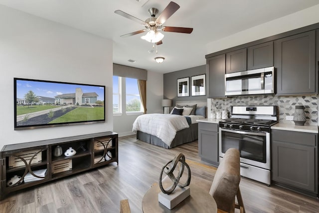 bedroom featuring ceiling fan and light hardwood / wood-style flooring