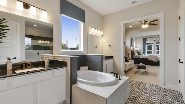 bathroom with ceiling fan, separate shower and tub, and vanity