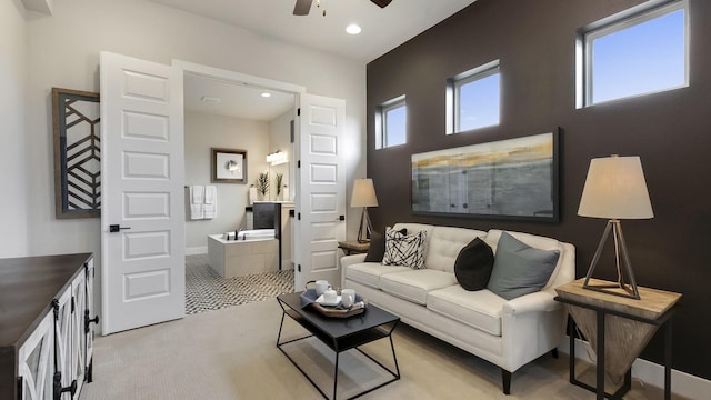 living room with ceiling fan and light colored carpet